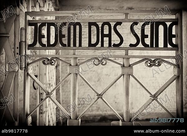 Entrance gate to beech forest concentration camp with the saying JEDEM DAS SEINE in Bauhaus script by Franz Ehrlich; former concentration camp beech forest; today memorial; black and white; vintage; Weimar; Thuringia; Germany; Europe.