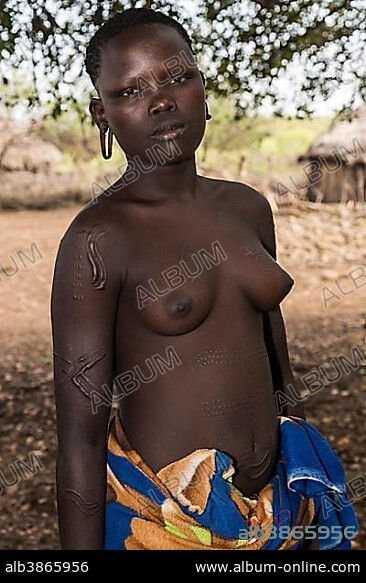 Young woman with ornamental scars on her body, tribe of the Mursi, Southern Nations Nationalities and Peoples' Region, Ethiopia, Africa.