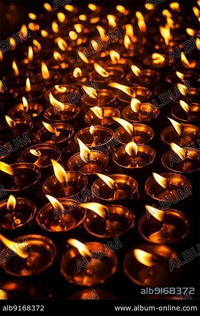 Burning candles in Tibetan Buddhist temple. Himachal Pradesh, India, Asia.