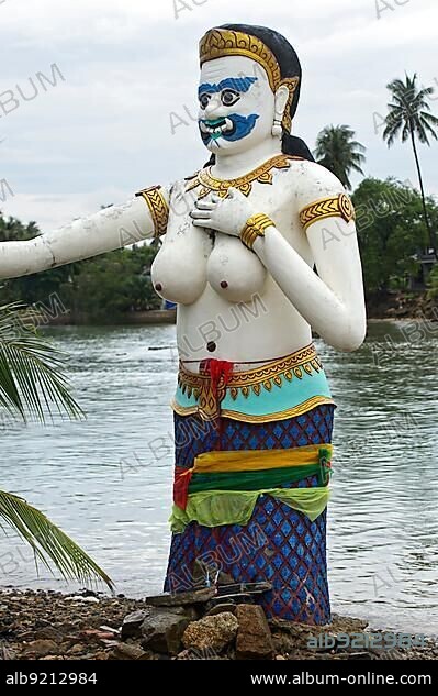 Bare-breasted mermaid statue with masculine features stands on the shore, Buddhist temple Wat Phra Yai, Ko Phan Island, Koh Samui, Thailand, Asia.