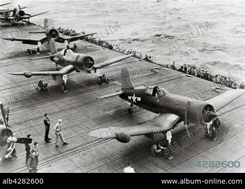 American single-engine Vought F4U Corsair fighter planes, preparing for take-off on the flight deck of the heavy aircraft carrier "Intrepid" of the US Navy, somewhere in the Pacific, 1944 or 1945.. The "Intrepid" is perserved as a floating museum in New York.. The Corsair, of which 12,681 planes were built as of its 1st flight on May 29, 1940, was the best carrier fighter plane of World War II.