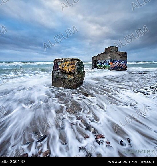 Old bunkers with graffiti in the surf of the Baltic Sea below the steep coast at stormy sea, high shore, seaside resort Wustrow, peninsula Fischland-Darß-Zingst, Western Pomerania Lagoon Area National Park, Mecklenburg-Western Pomerania, Germany, Europe.