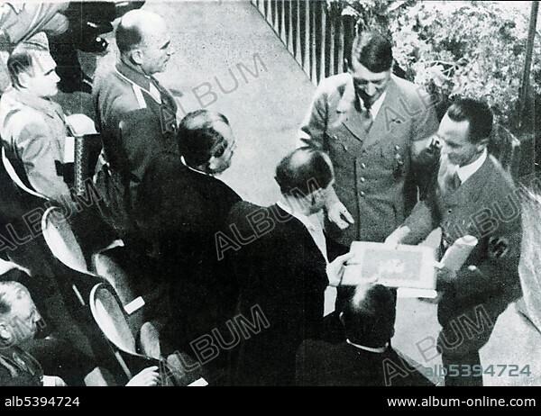Adolf Hitler and Josef Goebbels award the national prize for art and science to Dr. Porsche, Prof. Messerschmidt and Prof. Heinkel. On the upper left side Rudolf Hess, historical photo circa 1938.
