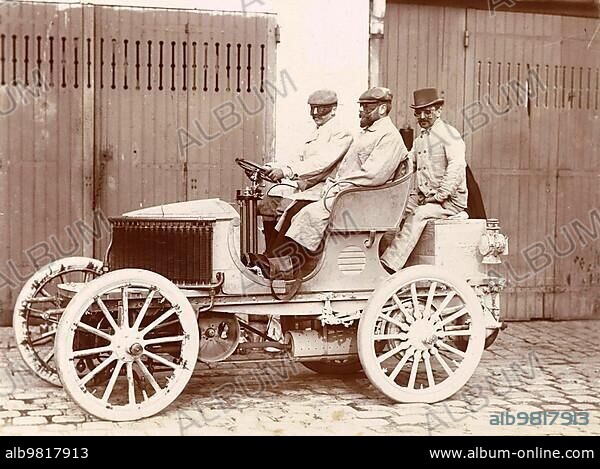 History of the Automobile; Three men with goggles in a car; probably in France; 1900; digitally restored reproduction from a 19th-20th century original.
