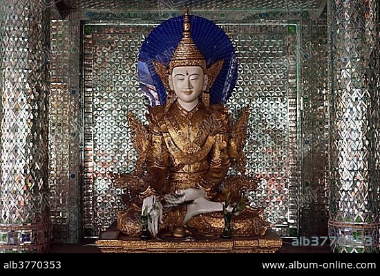 Buddha statue inside a shrine with mirror mosaic, Shwedagon Pagoda, Yangon, Myanmar, Asia.