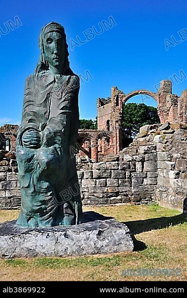 Statue of Saint Cuthbert of Lindisfarne, ruins of the Benedictine monastery of Lindisfarne, Lindisfarne, Northumbria, England, United Kingdom, Europe.