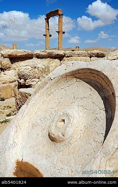 Millstone in the ruins of the Palmyra archeological site, Tadmur, Syria, Asia.