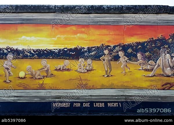 Henry Schmidt, Many small naked children playing alongside their parents, painting by Henry Schmid on the remants of the Berlin Wall, East Side Gallery, Friedrichshain district, Berlin, Germany, Europe.