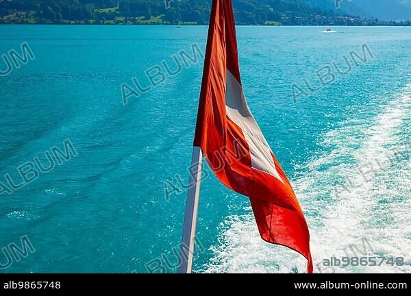 Swiss Flag over Lake Brienz in a Sunny Day in Interlaken, Bernese Oberland, Bern Canton, Switzerland, Europe.