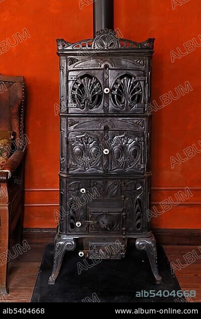 Cast iron stove, circa 1900, living room in the teacher's apartment, school building from Pfaffenhofen, built in 1801, Franconian open-air museum, Eisweiherweg 1, Bad Windsheim, Middle Franconia, Bavaria, Germany, Europe.