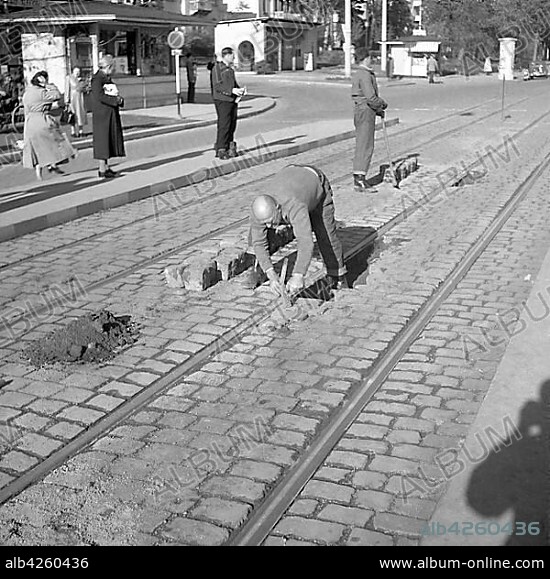 Construction workers paving a road around 1950, Freiburg, Germany, Europe.