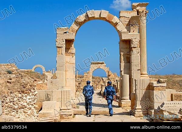 Policemen dressed in blue uniform patrol on cardo in the aechaeological site Leptis Magna Libya.