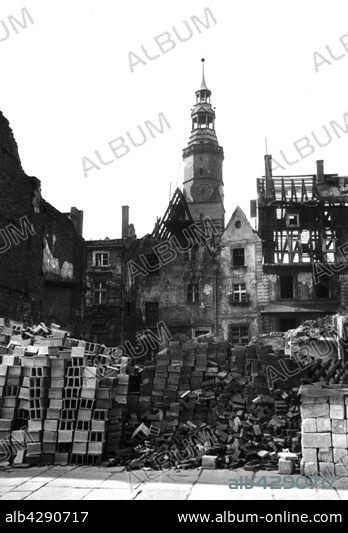 Breslau (now Wroclaw), Silesia, Poland: recycled materials (bricks, parpens, stones) piled up for reconstruction, in the Square of the City Hall (Rynek or Rathaus) of houses in ruins, late 1945.