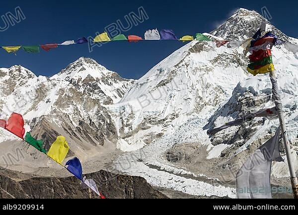 Classic view of Mount Everest, also called Chomolungma or Sagarmatha, from Kala Patthar, the famous trekking peak and viewpoint in the Himalayas. The colourful Buddhist prayer flags are in the foreground. Its the Khumbu Glacier below, with its impressive Khumbu Icefall. The location of the Everest Base Camp on the glaciers bend is empty in autumn. The mountain-pass, Lho La, marks the Nepali border. Changtse peak and North Col are beyond it. Sagarmatha National Park, Everest Region, Solukhumbu, Nepal, Asia.