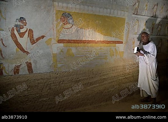 Grave guardian illuminating the mural of King Tanotamun on his deathbed in his grave, el-Kurru, Northern State, Nubia, Sudan, Africa.