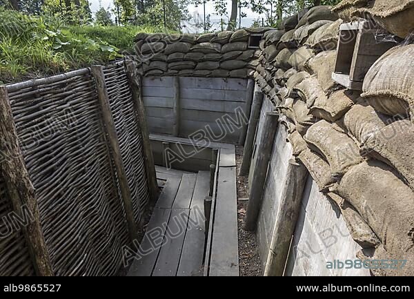 Reconstruction of German First World War One trench showing fire step, wooden duckboards, woven wickerwork branches and loopholes at Zonnebeke, Belgium, Europe.