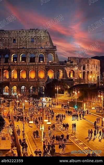 The Colosseum and Fori Imperiali in Rome Italy at sunset.