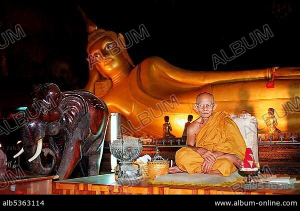 Monk and reclining Buddha, Khuha Sawan Cave, Phuket, Phangnga, Thailand, Asia.