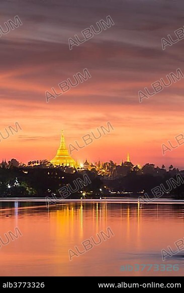 Illuminated Shwedagon Pagoda at sunset, The Great Dagon Pagoda, seen from Kandawgyi Lake, Yangon, Myanmar, Asia.