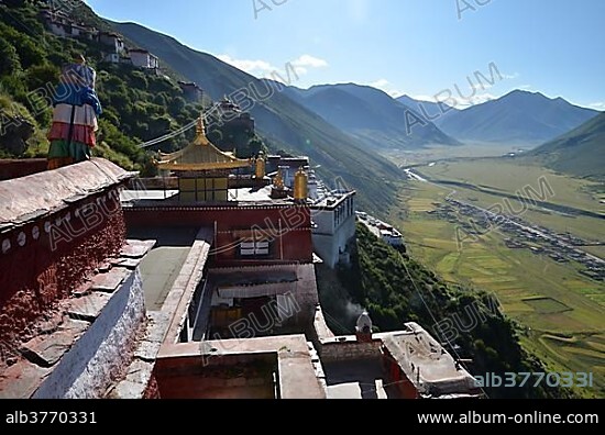 Tibetan Buddhism, golden roofs of Drigung Monastery, Drigung Til, views of a Tibetan village below, Meldro Gonkar, Lhundrup district, central Tibet, Tibet, Himalayas, China, Asia.