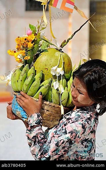 Girl carrying offerings, Botataung Pagoda, Yangon, Burma, Myanmar, Southeast Asia, Asia.