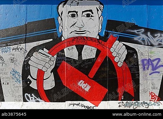 Georg Lutz (Rauschebart), Mural, Gorbachev sitting behind the wheel with the communist hammer symbol, painting on a remaining piece est of the Berlin Wall, East Side Gallery, Berlin-Friedrichshain, Berlin, Germany, Europe.