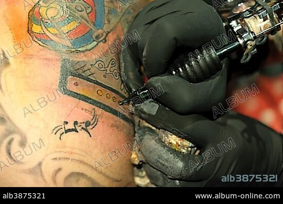 A young man is getting a tattoo, Freiburg im Breisgau, Baden-Württemberg, Germany, Europe.