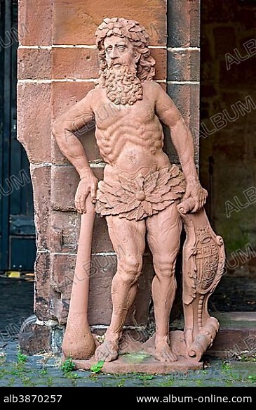 One of the "Wild Men" sandstone figures, guard and crest holder in front of the inner gatehouse, or Ludwigsbau, castle and residence Ysenburg, old town, Büdingen, Hesse, Germany, Europe.