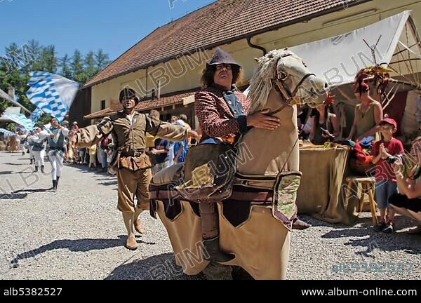 Man with mediaeval medieval costume riding on a horse dummy, knight festival Kaltenberger Ritterspiele, Kaltenberg, Upper Bavaria, Germany, Europe.