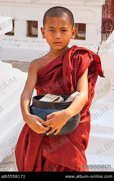 Monk with begging bowl in Shwezigon Pagoda, Bagan, Myanmar, Asia.