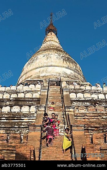 Visitors climb steep steps of Shwesandaw Pagoda, Bagan, Myanmar, Asia.