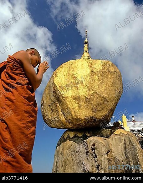 Buddhist Monk praying in front of the Golden Rock or Kyaiktiyo Pagoda, Kyaikto, Mon-Staat, Myanmar, Burma, Asia.