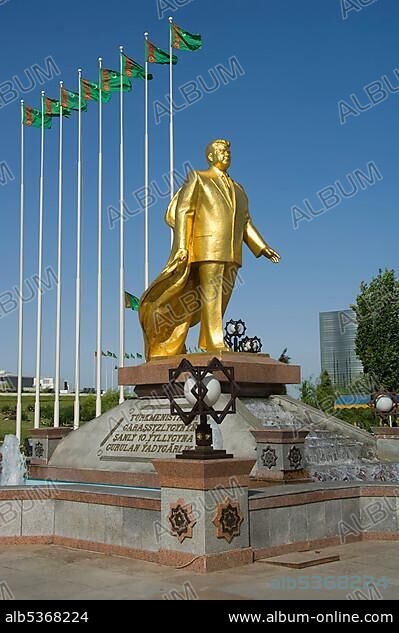 Gold covered statue of President Turkmenbasy in front of the monument of the 10th anniversary of Independence, Ashgabat, Turkmenistan, Asia.