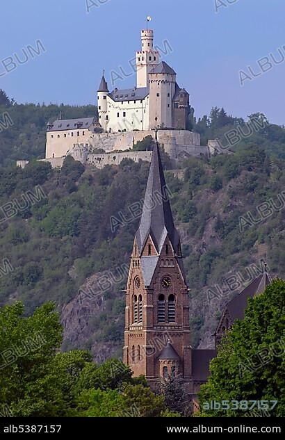 Marksburg, a castle above the town of Braubach with the church St.Lambertus in Spay in the foreground, Middle Rhine, Rhineland-Palatinate, Germany, Europe.