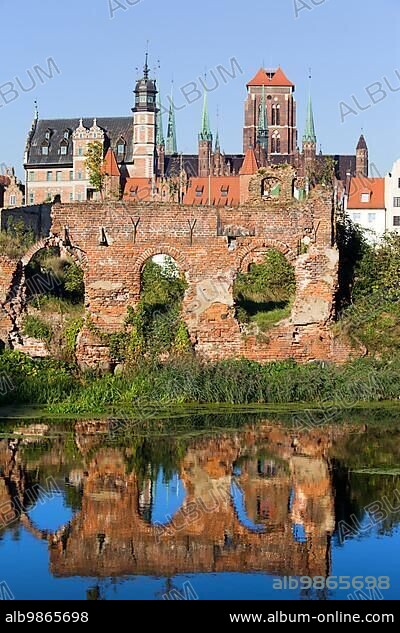 City of Gdansk (Danzig) in Poland, on the first plan ruins from the second World War with reflection on water.