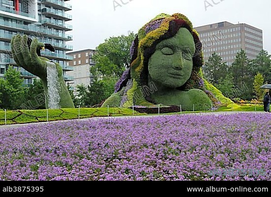 Plant sculpture Mother Earth with modern buildings behind, Mosaicanada Exhibition, Gatineau, Quebec Province, Canada, North America.