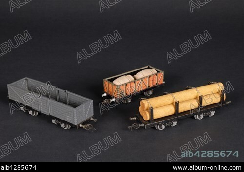 Toys. 3 JEP wagons, out of which : a black and red dump truck wagon, a grey and black dump truck wagon with opening doors, a black wagon loaded with wood. Private collection. Pétrini Family collection.