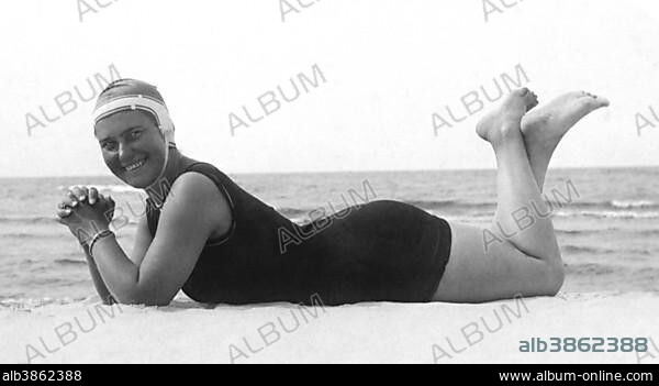 Fashion, swimwear, woman lying on the beach with swimsuit and bathing cap, 1930s, Rügen, Germany, Europe.