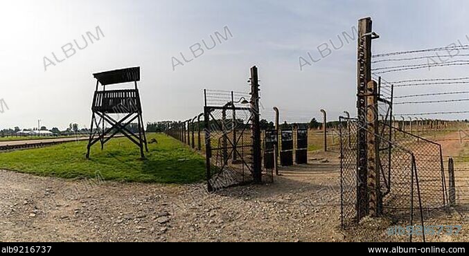 Auschwitz, Poland - 15 September, 2021: guard tower and prison camp gate at Auschwitz concentration camp in Poland.