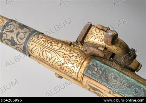 Detail from a caucasian flintlock pisto. 19th Century. Private collection. Round cannon decorated with golden leaves patterns. Ornaments in niellé silver, engraved. Ball butt in walrus ivory with golden decorations.