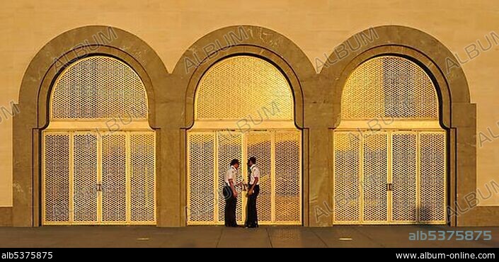 Security staff, gold-plated west entrance, Museum of Islamic Art, designed by I.M. PEI, evening atmosphere, Corniche, Doha, Qatar, Persian Gulf, Middle East, Asia.