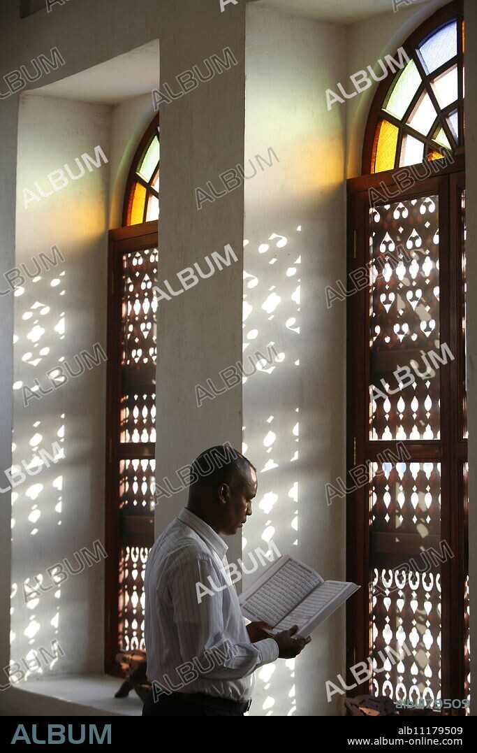 Man reading Koran in a Doha mosque, Doha, Qatar, Middle East.