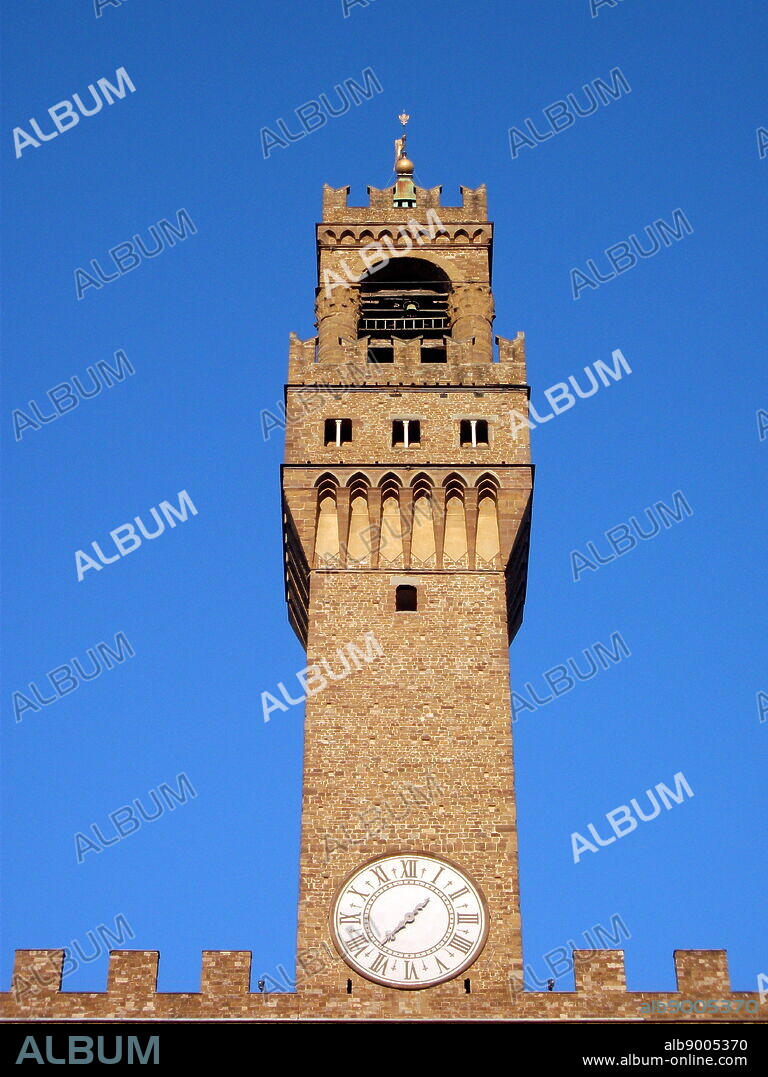 The clock tower of the Palazzo Vecchio. Town hall of Florence, Italy. A huge Romanesque fortress-palace overlooking the Piazza della Signoria. Designed by the architect Arnolfo di Cambio in 1299. A stonework cubicle building forms the base, crowned with a projected battlement clock tower. The current clock was made by Vincenzo Viviani in 1667. Arches in the structure are decorated with the 9 coats of arms of the Florentine Republic.