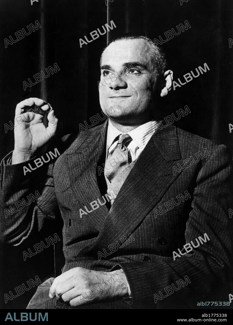 Alberto Moravia sitting with his hand raised. The Italian writer and journalist Alberto Moravia sitting with his hand raised.