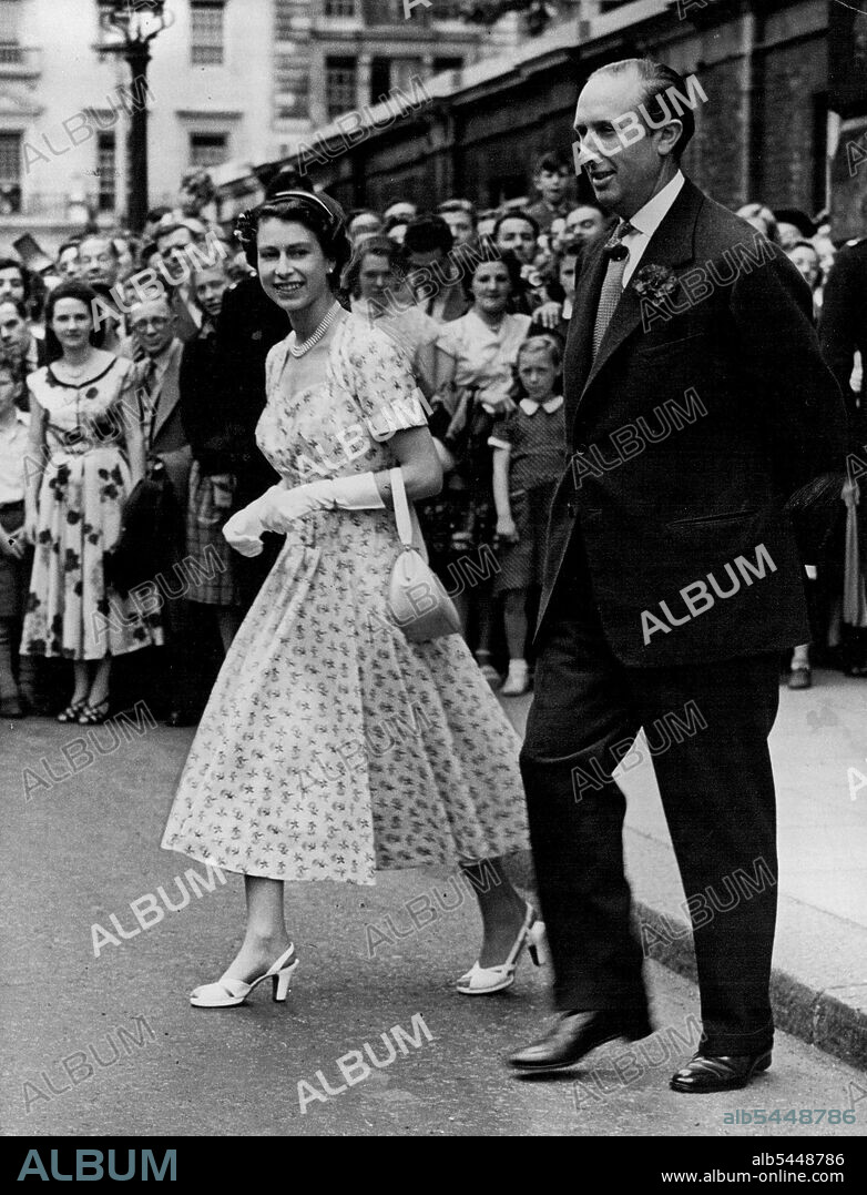At Last... Her Majesty Can Wear A Light Summer Dress -- Her Majesty the Queen is here seen with Brigadier Alexander Abel Smith, leaving the Queen's Chapel, after the Christening ceremony. Her Majesty the Queen to-day wore a light summer frock when she attended the Christening of the infant son of Brigadier and Mrs. Alexander Abel Smith, held this afternoon in the Queen's chapel, Marlborough House. August 04, 1954. (Photo by Paul Popper).
