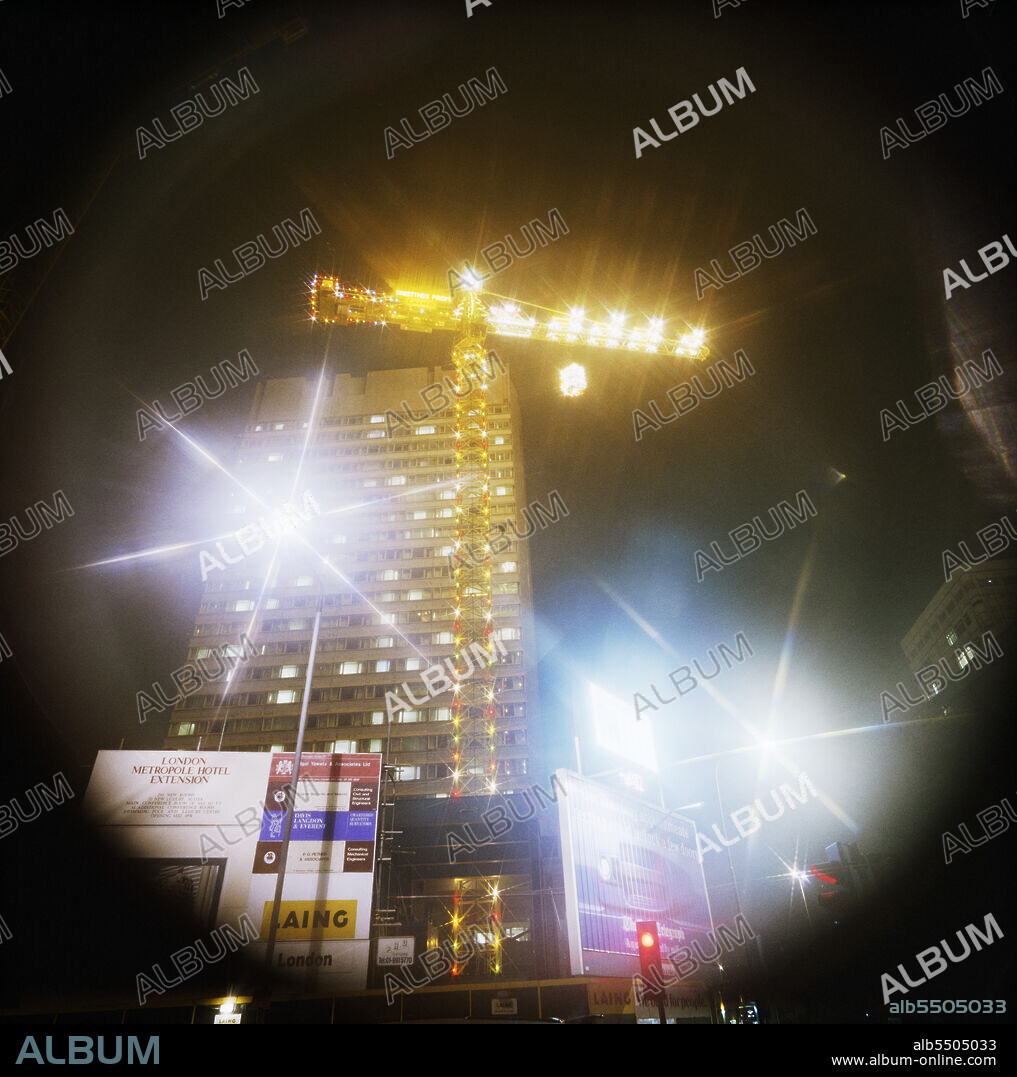 JOHN LAING PLC. London Metropole Hotel, Edgware Road, City of Westminster, London, November - December 1989. Laing's winning entry to the Financial Times Christmas Crane Competition at the Metropole Hotel, London. The team were given short notice that the crane at the Metropole site had been selected as Laing's entry for the competition, only finding out on 21st November.  EPL, Laing Plc's plant operation, came up with a design and it was fabricated by Jack Casey's group in St. Neots.  Bill MacDermott, EPL's Electrical Design Manager, designed the electrical circuitry at his dining room table in an afternoon.  The reindeers' legs and Father Christmas' arm was made to appear to move and the whole display took more than 2,400 bulbs.  Laing won the competition again the following year with a crane at the Vauxhall Cross site.A date of 4th November is given on the negative register but the story in the Jan 1990 issue of Team Spirit, Laing's company newsletter, suggests this is too early.