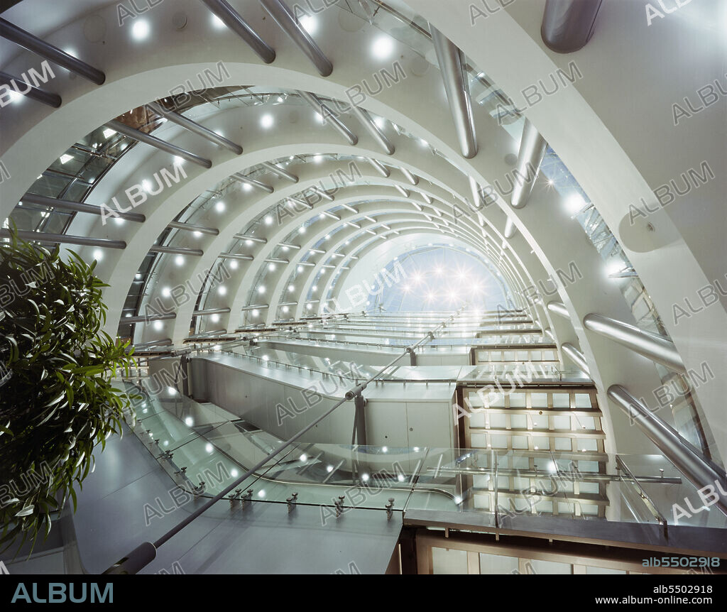 JOHN LAING PLC. 3 Minster Court, Mincing Lane, City of London, 12/10/1993. Looking up through the central atrium of 3 Minster Court, showing the underside of the suspended escalators. In October 1990, Laing’s London division were awarded the contract for the fitting out of the new London Underwriting Centre at No.3 Minster Court. Key parts of the contract included altering steelwork to enable 16 escalators to be suspended in the atrium, creating dining and kitchen areas on the mezzanine level and the installation of raised floors and suspended ceilings. In August 1991, the team faced a huge setback as the site was severely damaged by fire. The flames swept through the central atrium and burst through the roof. A new Laing team was formed to restore the building after the disaster, and work was finally completed in late 1993.