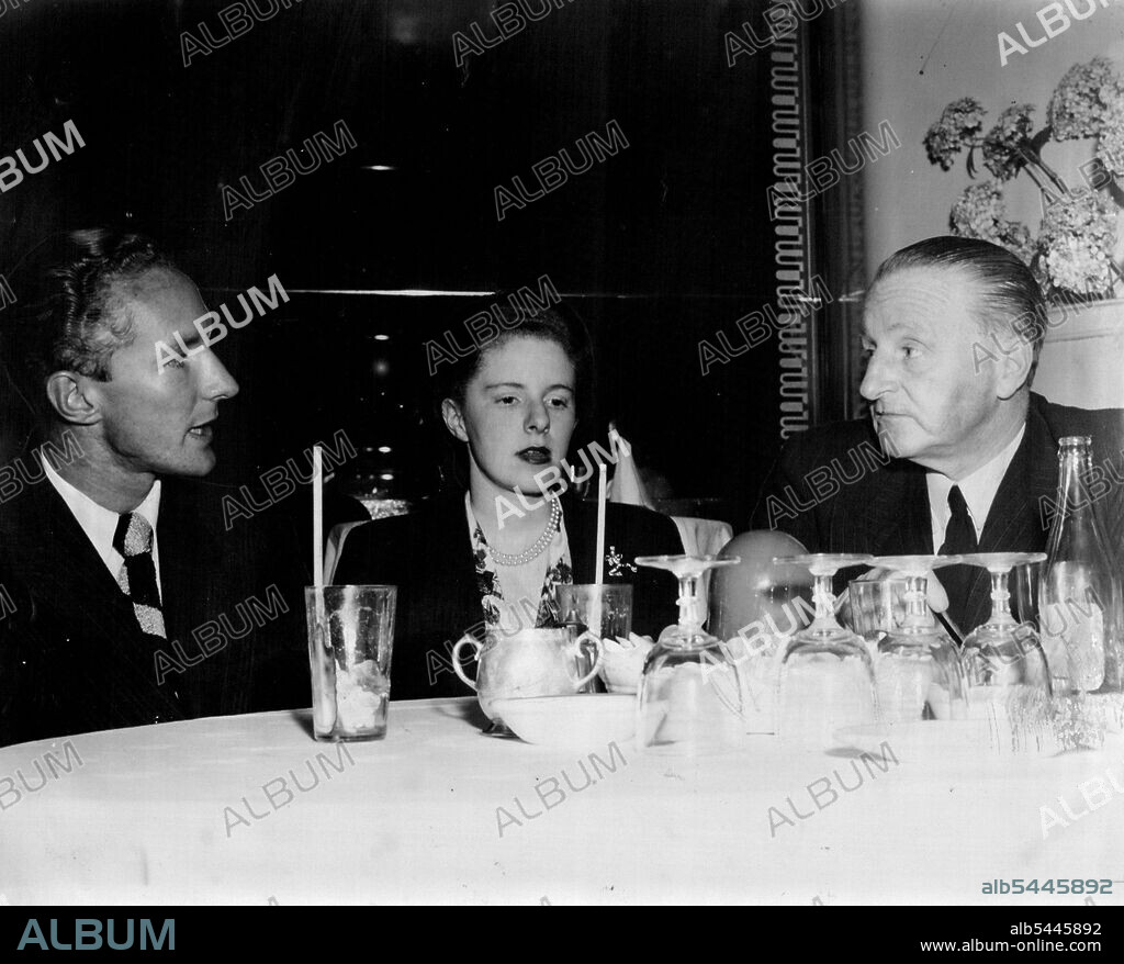 Family Dinner at Prince's during the week for John Plowman (left) Janet Plowman and their father, Sir Claude Plowman, Janet wore a black jacket ***** her floral Jersey dinner dress. January 14, 1951.
