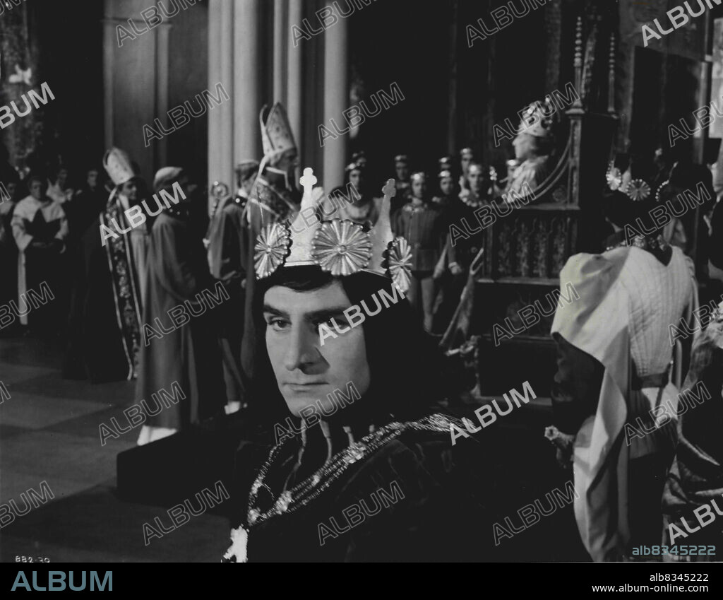 After Edward IV (Sir Cedric Hardwicke) has been crowned king of England by the Archbishop of Canterbury (Nicholas Hannen), Richard, Duke of Gloucestershire (Sir Laurence Olivier) turns to give Buckingham a cynical look.A scene from Sir Laurence Olivier's latest Shakespearean screen production "Richard III", in which he again acts in the three-fold capacity of producer, director and principal player in the title role."Richard III" which is produced, in association, by London films and Laurence Olivier Productions, is being filmed in Vistavision and in Eastman Colour at Shepperton Studios. May 26, 1955. (Photo by London Films International Ltd.).