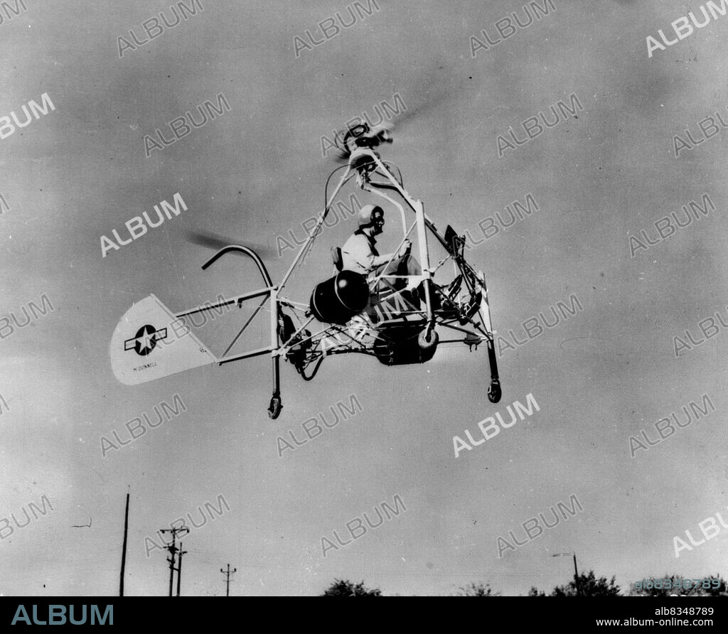 Helicopter Motorcycle In Flight -- The Air Forces' New Helicopter motorcycle, powered by ram jet units to spin the rotor blades, makes a test flight at the St. Louis, Mo., plant of the McDonnel Aircraft corporation. The craft eights only 310 pounds but has lifted an additional load of 300 pounds and moved at a speed of 50 miles an hour. November 15, 1947. (Photo by Associated Press Photo).